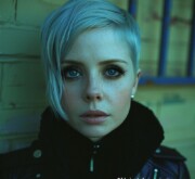 A woman with a fashionable fantastic gray hairdo