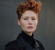 Woman showcasing a modish short red hairdo