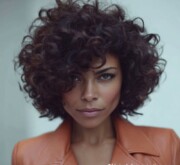 Elegant short brown haircut woman with bouncy curls