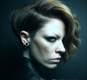 Sleek short blonde female cut with polished edges Sleek short blonde female cut with polished edges